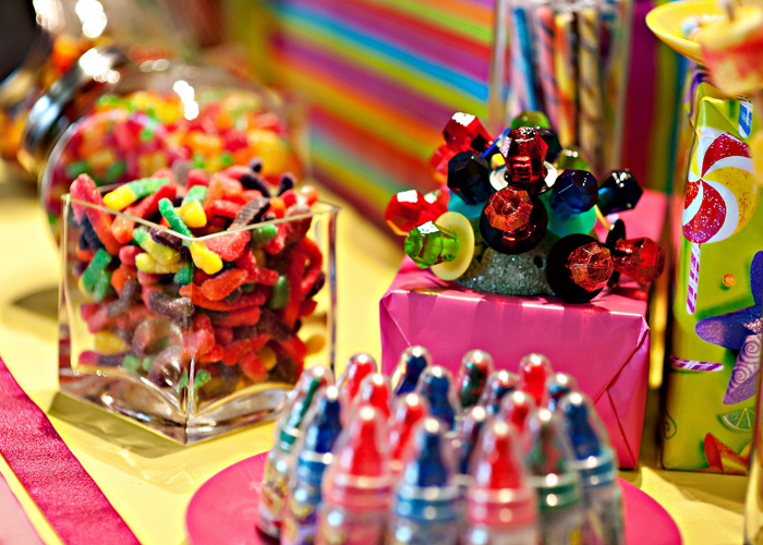 Gummy worms and ring pops arranged on candy table for Candy Land birthday party