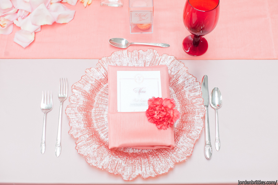 Blush charger with blush napkin and wedding menu on a blush light pink table