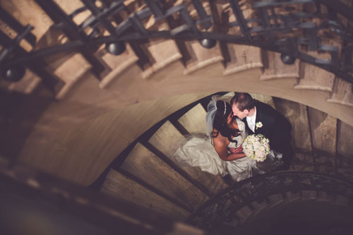 Bride & Groom in spiral staircase | Events Luxe Weddings